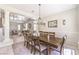 Elegant dining room showcasing an oversized table, chandelier and view into the living room at 4737 Barcelona Ridge Ct, Las Vegas, NV 89129