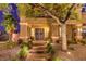 Exterior front entrance showcasing a covered porch and decorative desert landscaping at night at 4737 Barcelona Ridge Ct, Las Vegas, NV 89129