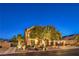 Exterior of a two-story house at dusk with desert landscaping and a three-car garage at 4737 Barcelona Ridge Ct, Las Vegas, NV 89129