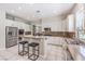 Well-lit kitchen with white cabinetry, granite countertops, stainless steel appliances, and tiled flooring at 4737 Barcelona Ridge Ct, Las Vegas, NV 89129