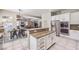 Spacious kitchen with stainless steel appliances, granite countertops, and open floor plan to the dining and living areas at 4737 Barcelona Ridge Ct, Las Vegas, NV 89129