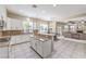 Open kitchen with white cabinets, granite counters, stainless appliances, and an adjacent dining and living area at 4737 Barcelona Ridge Ct, Las Vegas, NV 89129