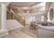 Elegant living room with soaring ceilings, wrought iron stair case and neutral earth tone decor at 4737 Barcelona Ridge Ct, Las Vegas, NV 89129