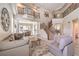 Spacious living room with high ceilings, wrought iron staircase, and neutral decor at 4737 Barcelona Ridge Ct, Las Vegas, NV 89129