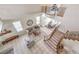 High-angle view of the open-concept living room with a staircase and wrought iron railings at 4737 Barcelona Ridge Ct, Las Vegas, NV 89129