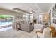 Inviting living room with a fireplace, comfortable seating, and sliding glass doors leading to a pool area at 4737 Barcelona Ridge Ct, Las Vegas, NV 89129