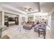 Large living room with comfortable seating, entertainment center, and open access to the kitchen and dining area at 4737 Barcelona Ridge Ct, Las Vegas, NV 89129