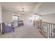 Comfortable loft featuring a seating area, soft carpet, and natural light from the surrounding windows at 4737 Barcelona Ridge Ct, Las Vegas, NV 89129