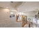 Spacious loft area with plush carpeting, elegant railings, and views of the living spaces below at 4737 Barcelona Ridge Ct, Las Vegas, NV 89129