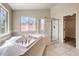 Inviting main bathroom with soaking tub, glass enclosed shower, and a walk-in closet at 4737 Barcelona Ridge Ct, Las Vegas, NV 89129