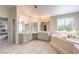 Bright main bathroom featuring dual sinks, soaking tub, and decorative privacy window at 4737 Barcelona Ridge Ct, Las Vegas, NV 89129