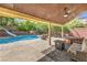 A lovely covered patio area with a view of the pool, hot tub, and slide at 4737 Barcelona Ridge Ct, Las Vegas, NV 89129