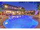 Backyard pool at dusk with a water slide, patio furniture, and a beautifully landscaped yard at 4737 Barcelona Ridge Ct, Las Vegas, NV 89129