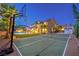 Backyard sport court and home with a pool, lounge chairs, manicured lawn, and privacy landscaping, enhancing outdoor living at 4737 Barcelona Ridge Ct, Las Vegas, NV 89129