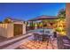 Backyard with storage shed, outdoor dining area under an umbrella, and a sport court, creating versatile spaces at 4737 Barcelona Ridge Ct, Las Vegas, NV 89129