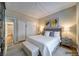 Calm bedroom with hardwood floors, ensuite, and a bench seat at the foot of the bed at 5170 Agio Ave, Pahrump, NV 89061