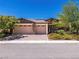 Charming single-story home featuring stone accents, a three-car garage, and well-maintained landscaping at 5170 Agio Ave, Pahrump, NV 89061
