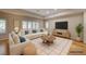 Bright living room with large windows, sectional sofa, and hardwood floors at 5170 Agio Ave, Pahrump, NV 89061