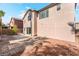Spacious backyard featuring a brick patio, desert landscaping, and a sliding glass door for seamless indoor-outdoor living at 5340 Santa Fe Heights St, North Las Vegas, NV 89081