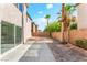 Private backyard oasis complete with mature palm trees, desert landscaping, and a paved patio area for entertaining at 5340 Santa Fe Heights St, North Las Vegas, NV 89081