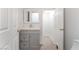 Bathroom featuring a gray vanity, chrome faucet, and light-colored flooring with a view into a closet and toilet area at 5340 Santa Fe Heights St, North Las Vegas, NV 89081