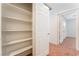 Walk-in closet with built-in shelving and a view into another bedroom and bathroom at 5340 Santa Fe Heights St, North Las Vegas, NV 89081