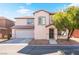 Charming two-story home with a well-kept lawn, desert landscaping, and an attached two-car garage at 5340 Santa Fe Heights St, North Las Vegas, NV 89081