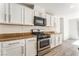 Updated kitchen with stainless steel appliances, granite countertops, and white cabinetry providing a bright, modern space at 5340 Santa Fe Heights St, North Las Vegas, NV 89081