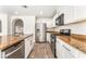 Updated kitchen featuring stainless steel appliances, white cabinets, granite countertops, and a center island at 5340 Santa Fe Heights St, North Las Vegas, NV 89081