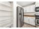 Kitchen showcasing stainless steel refrigerator, gas range and stove, and ample storage space with white cabinetry at 5340 Santa Fe Heights St, North Las Vegas, NV 89081