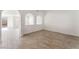 Spacious room with wood-look tile flooring, neutral paint, and arched design features create architectural interest at 5340 Santa Fe Heights St, North Las Vegas, NV 89081