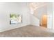Bright and airy living room with vaulted ceilings, wood-look tile flooring, and abundant natural light at 5340 Santa Fe Heights St, North Las Vegas, NV 89081