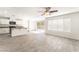 Open-concept living area with wood-look tile flooring, ceiling fan, and access to a patio at 5340 Santa Fe Heights St, North Las Vegas, NV 89081