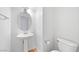 Half-bathroom features a pedestal sink and toilet with a neutral color scheme at 5526 Spruce Hill Ct, Las Vegas, NV 89148