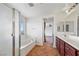 Bright bathroom featuring a tub with glass enclosure and double vanity at 5526 Spruce Hill Ct, Las Vegas, NV 89148