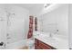 This bathroom features tile flooring, a shower-tub, and a single sink vanity at 5526 Spruce Hill Ct, Las Vegas, NV 89148