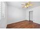 Bright bedroom featuring wood-look floors, ceiling fan and shutters at 5526 Spruce Hill Ct, Las Vegas, NV 89148