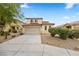 Charming two-story home with a spacious driveway and desert landscaping at 5526 Spruce Hill Ct, Las Vegas, NV 89148