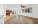 Open-concept living area flows to the kitchen featuring wood floors and bright lighting at 5526 Spruce Hill Ct, Las Vegas, NV 89148