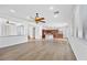 Open-concept living area flows to the kitchen featuring wood floors and bright lighting at 5526 Spruce Hill Ct, Las Vegas, NV 89148