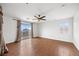 Main bedroom features neutral walls, dark wood floor, a ceiling fan, and sliding door access to a balcony at 5526 Spruce Hill Ct, Las Vegas, NV 89148