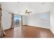 Primary bedroom boasts dark floors, a ceiling fan, curtains, and bright, natural lighting at 5526 Spruce Hill Ct, Las Vegas, NV 89148