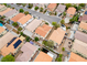 Aerial view of a neighborhood with diverse terracotta roofs, mature trees, and paved streets at 5526 Spruce Hill Ct, Las Vegas, NV 89148