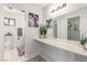 Bright bathroom featuring a long vanity with dual mirrors and an adjacent toilet at 5905 Paseo Montana, Las Vegas, NV 89108