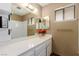Bathroom vanity with framed mirror, lighting, and storage at 5905 Paseo Montana, Las Vegas, NV 89108