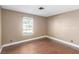 Bedroom with wood-look floors, window, and neutral paint at 5905 Paseo Montana, Las Vegas, NV 89108