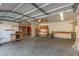 Spacious garage interior with shelving and workbench offering ample storage and workspace at 5905 Paseo Montana, Las Vegas, NV 89108