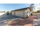 Exterior shot of the detached garage with two doors with a brick pathway leading to the pool at 5905 Paseo Montana, Las Vegas, NV 89108