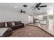 Open-concept living room featuring tile floors leading to modern kitchen with stainless steel appliances at 5905 Paseo Montana, Las Vegas, NV 89108