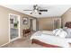 Bright main bedroom showcasing a bed, desk, and doorway to the adjoining bathroom at 5905 Paseo Montana, Las Vegas, NV 89108